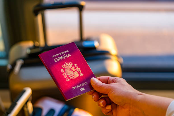 Close up of woman hand holding Spanish passport. High resolution 42Mp indoors digital capture taken with Sony A7rII and Sony FE 90mm f2.8 macro G OSS lens
